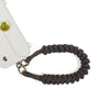 Wrist strap anchored to charging port for safety in caramel brown