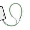 Adjustable mint green phone crossbody strap connected to iPhone charging port