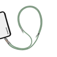 Adjustable mint green phone crossbody strap connected to iPhone charging port